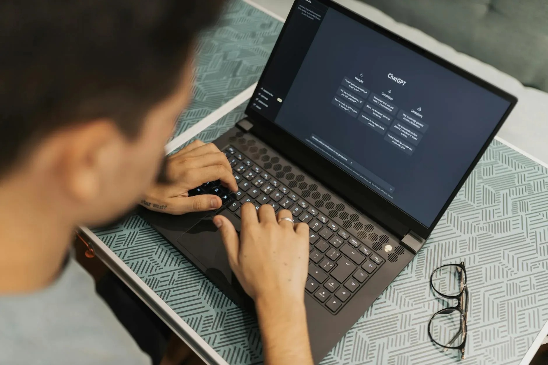 Person typing on laptop with AI tools — deal sourcing workflow for investors
